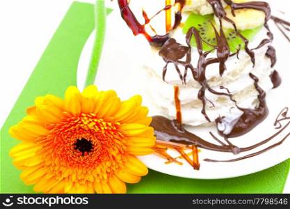 cake with cream caramel heart and Gerbera lying on a green cloth