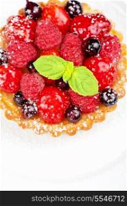 Cake with fresh berries and mint closeup