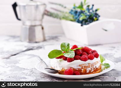 cake with raspberry and cream on a table