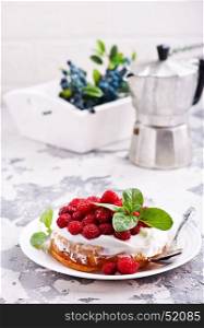 cake with raspberry and cream on a table