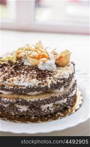 cake with walnuts and physalis. Chocolate cake with walnuts and physalis