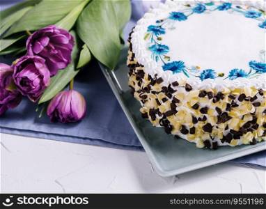 cake with white cream and flowers tulips