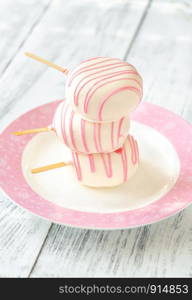 Cakes in the shape of popsicles on the dessert plate