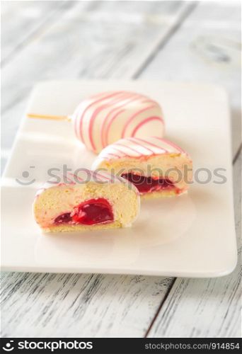 Cakes in the shape of popsicles on the white plate: cross section