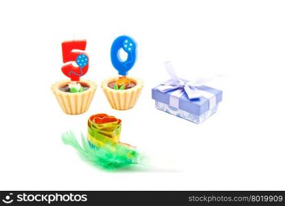 cakes with fifty years birthday candles, whistle and gift on white
