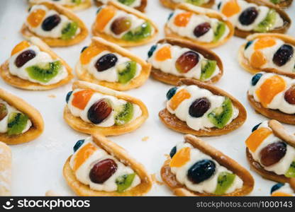 cakes with pieces of fruit cream are on a baking tray and ready to eat