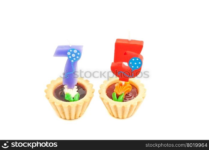 cakes with seventy five years birthday candles on white