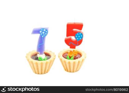 cakes with seventy five years birthday candles on white background