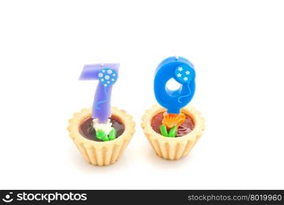 cakes with seventy years birthday candles on white background
