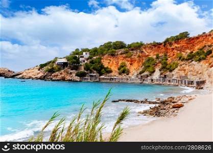 Cala d Hort Ibiza beach with traditional wood boat mooring in Balearic island