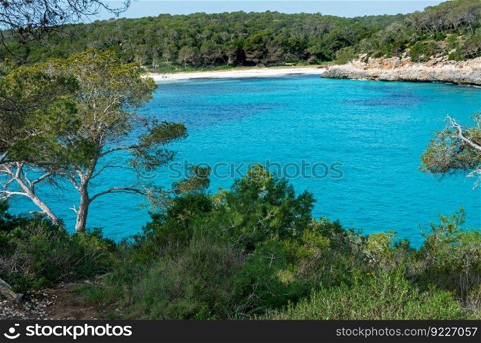 Cala Mondrago is a secluded resort beach in Mallorca with calm waters sheltered by surrounding headlands