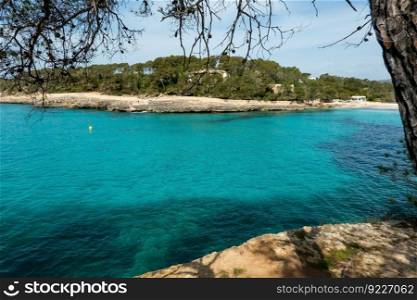 Cala Mondrago is a secluded resort sandy beach in Mallorca with calm waters sheltered by surrounding headlands