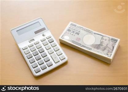 Calaculator and a bundle of japanese money
