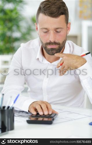 calculator and man working in the office