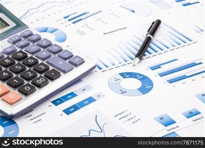 calculator and pen with blue business charts, graphs, infomation and reports background for financial and business concepts