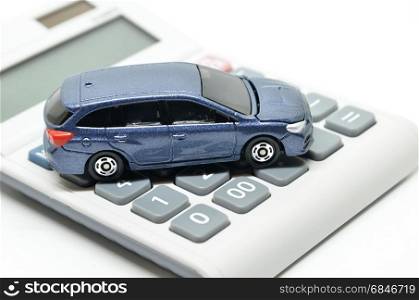 Calculator and toy car isolated on white background. Calculator and toy car