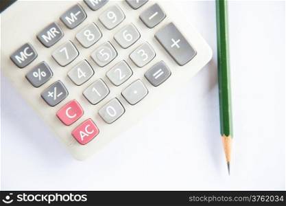 Calculator, glasses, pencil and protractor scale. Placed on desk