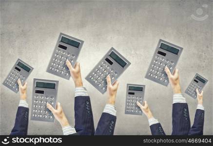 Calculator in hands. Many hands of business people holding calculators