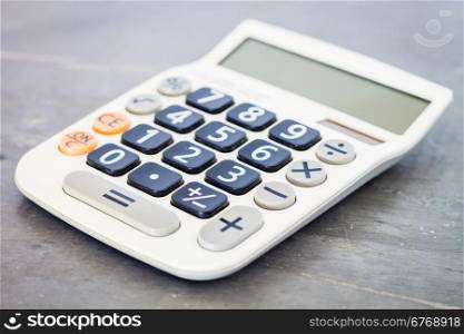 Calculator on grey background, stock photo