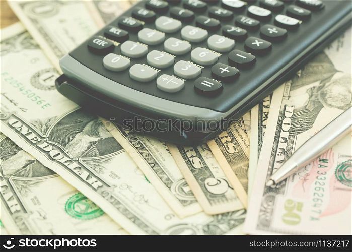 calculator on the background of Money dollar banknotes. soft focus.