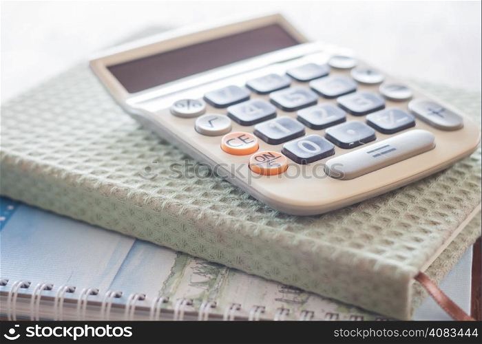 Calculator on two of notebooks, stock photo