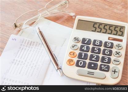 Calculator, pen and eyeglasses with bank account passbook, stock photo