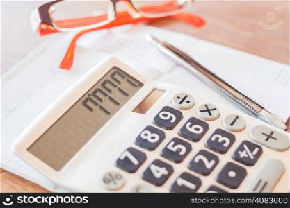 Calculator, pen and on bank account passbook, stock photo