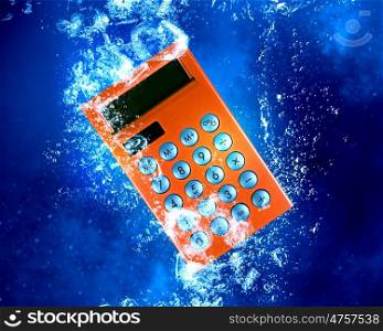 Calculator under water. Calculator item sink in clear blue water
