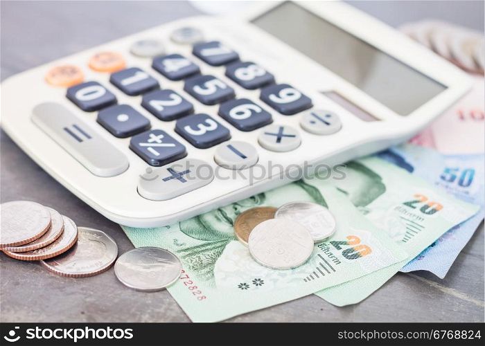 Calculator with money on grey background, stock photo