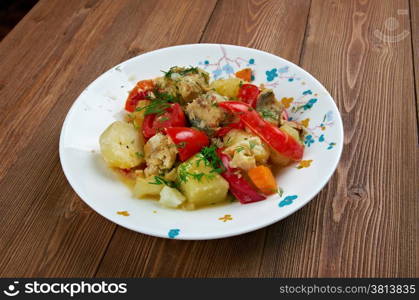 Caldeirada Portuguese fish stew,dish include vegetables - potatos, onions, green peppers, tomatoes.