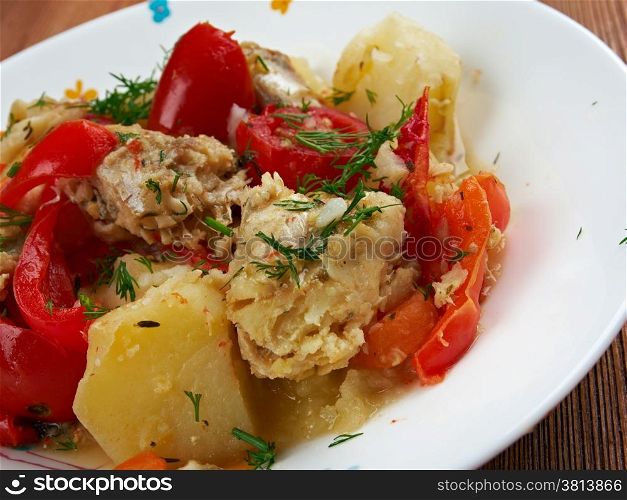 Caldeirada Portuguese fish stew,dish include vegetables - potatos, onions, green peppers, tomatoes.