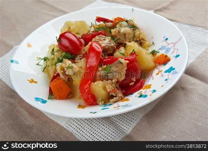 Caldeirada Portuguese fish stew,dish include vegetables - potatos, onions, green peppers, tomatoes.