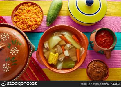 Caldo de res Mexican beef broth in table with sauces
