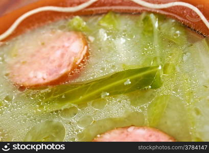 Caldo verde popular soup in Portuguese cuisine. traditional ingredients for caldo verde are potatoes, collard greens , olive oil and salt. Additionally garlic or onion may be added.