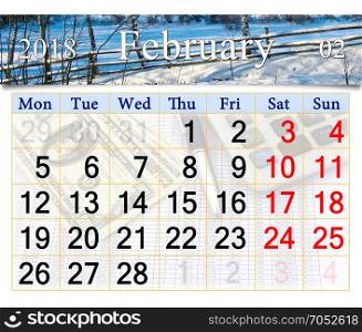 calendar for February of 2018 with winter landscape. calendar for February of 2018 with image of snow-covered fence in the village