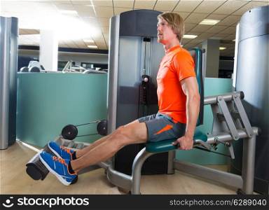 Calf extension blond man at gym exercise machine workout indoor
