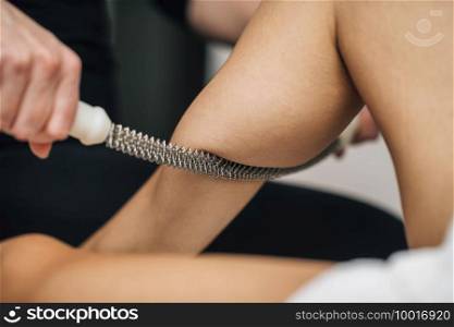 Calf massage with a rolling pin in a beauty salon. Calf Massage with Rolling Pin