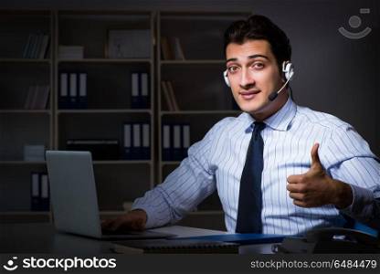 Call center operator talking to customer during night shift