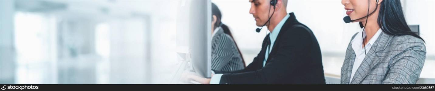 Call center or customer support agent in broaden view panorama banner wearing headset while working at office to support remote customer or colleague on telephone video conference call. Call center or customer support agent in broaden view panoramic banner