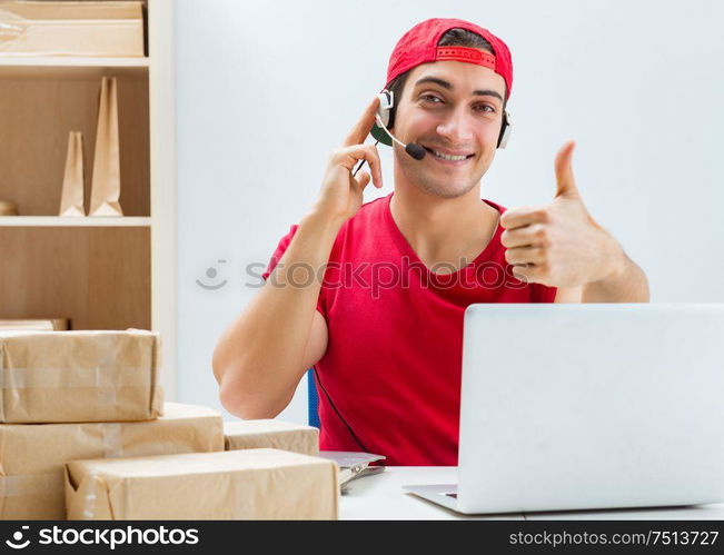 Call center worker at parcel distribution center in post office. The call center worker at parcel distribution center in post off