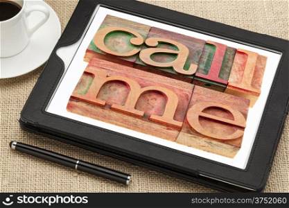 call me request or reminder - words in vintage wooden letterpress printing blocks on a digital tablet with a cup of coffee