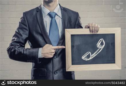 Calling skills. Close up of businessman holding wooden frame with calling concept