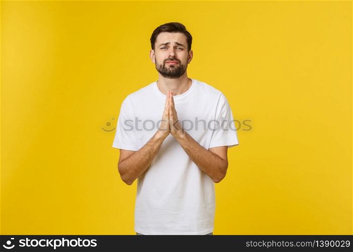 Calm and handsome. Portrait of handsome young man keeping hands clasped and looking thoughtful. Calm and handsome. Portrait of handsome young man keeping hands clasped and looking thoughtful.