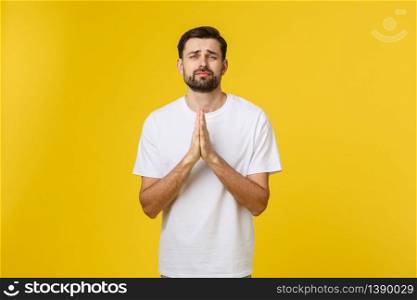 Calm and handsome. Portrait of handsome young man keeping hands clasped and looking thoughtful. Calm and handsome. Portrait of handsome young man keeping hands clasped and looking thoughtful.