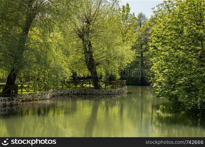 Calm and peaceful river in the park by Postojnska Jama in Slovenia. Calm peaceful river in the park near Postojna cave system in Slovenia