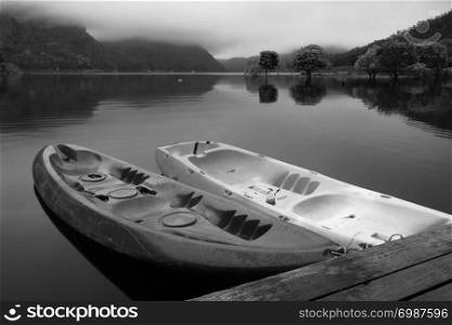 Calm black and white landscape with lake and canoe parking