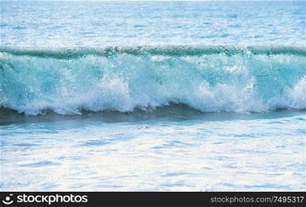Calm blue seascape with white surf wave on foreground