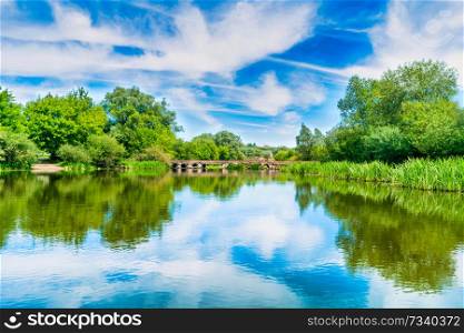 Calm landscape with blue river and green trees