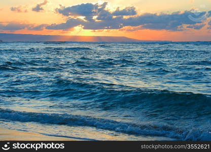 Calm peaceful ocean and beach on tropical sunrise