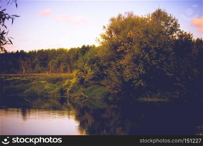 Calm river and green forest, nice peaceful landscape, vintage effect.